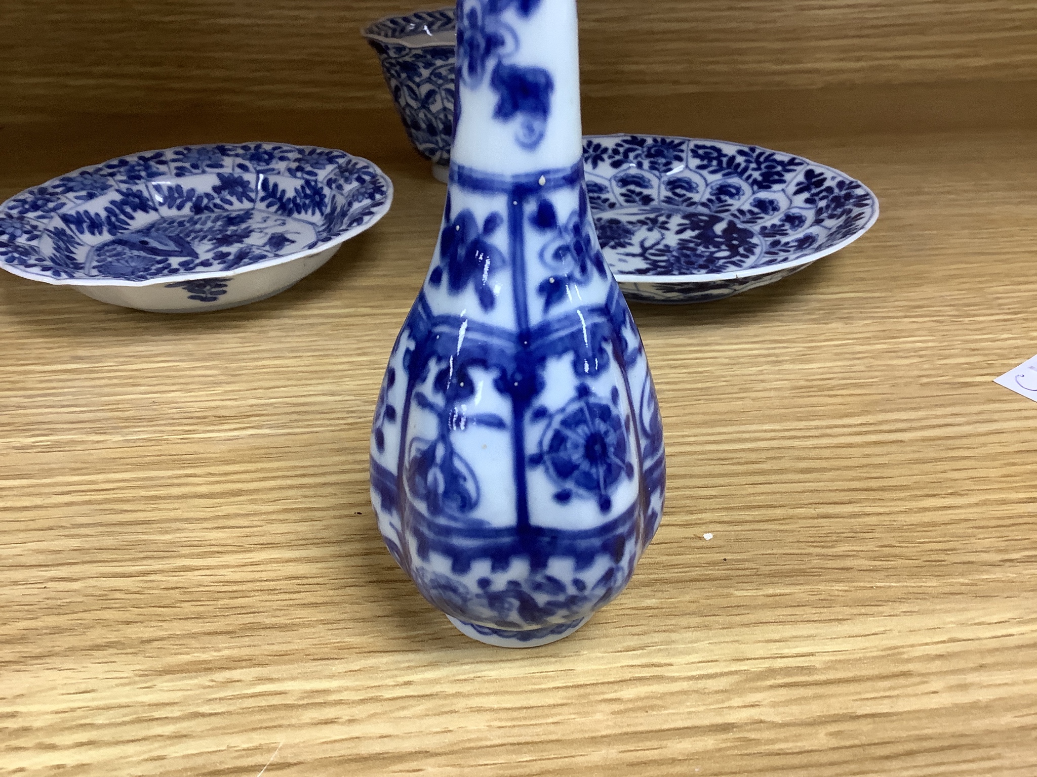 A Chinese blue and white plate 13cm diameter, a similar tea bowl and saucer, Kangxi period and a 19th century Chinese blue and white bottle vase